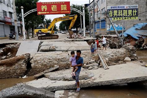 A mudslide kills at least 2 in China while rain from Khanun cancels some trains in the northeast